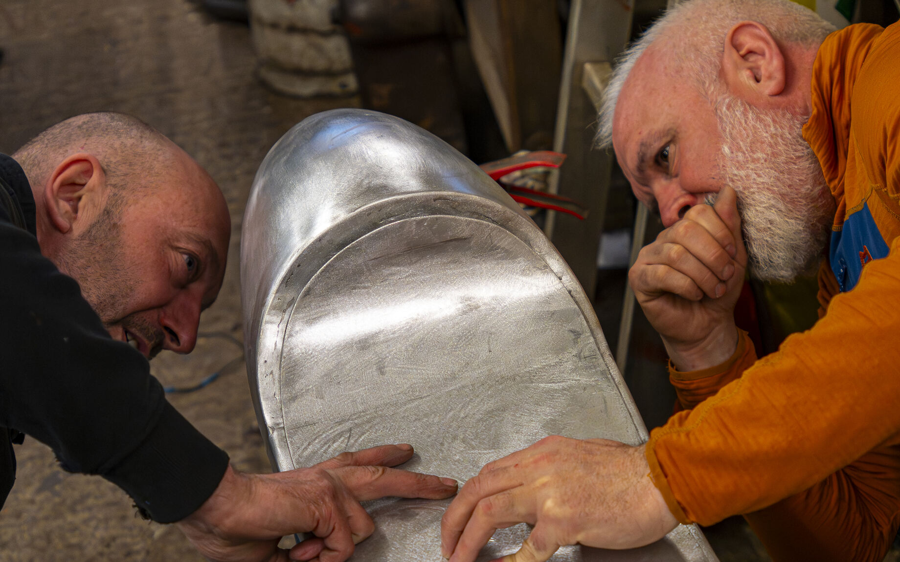 A hand-shaped aluminium seat unit checked over on the bench