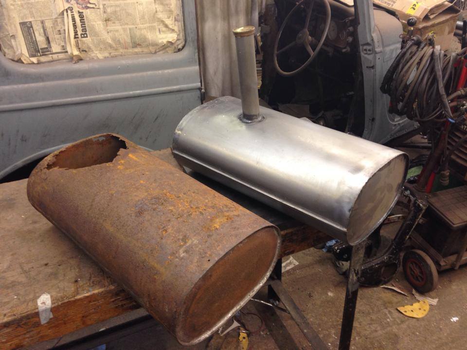 A rusted tank beside its newly fabricated replacement