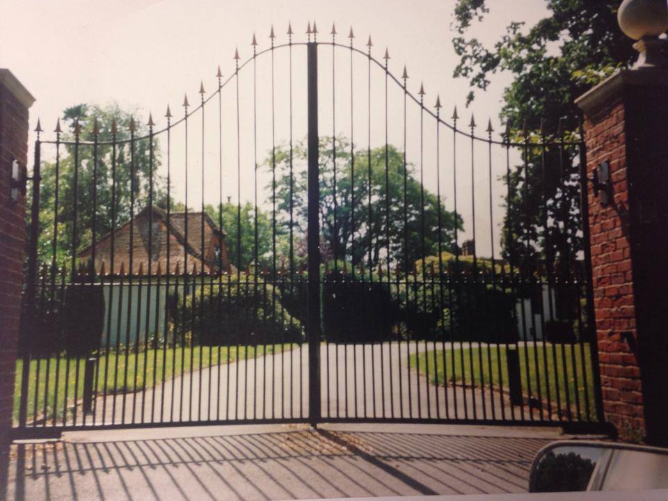 Arched wrought-iron double gates with spear finials
