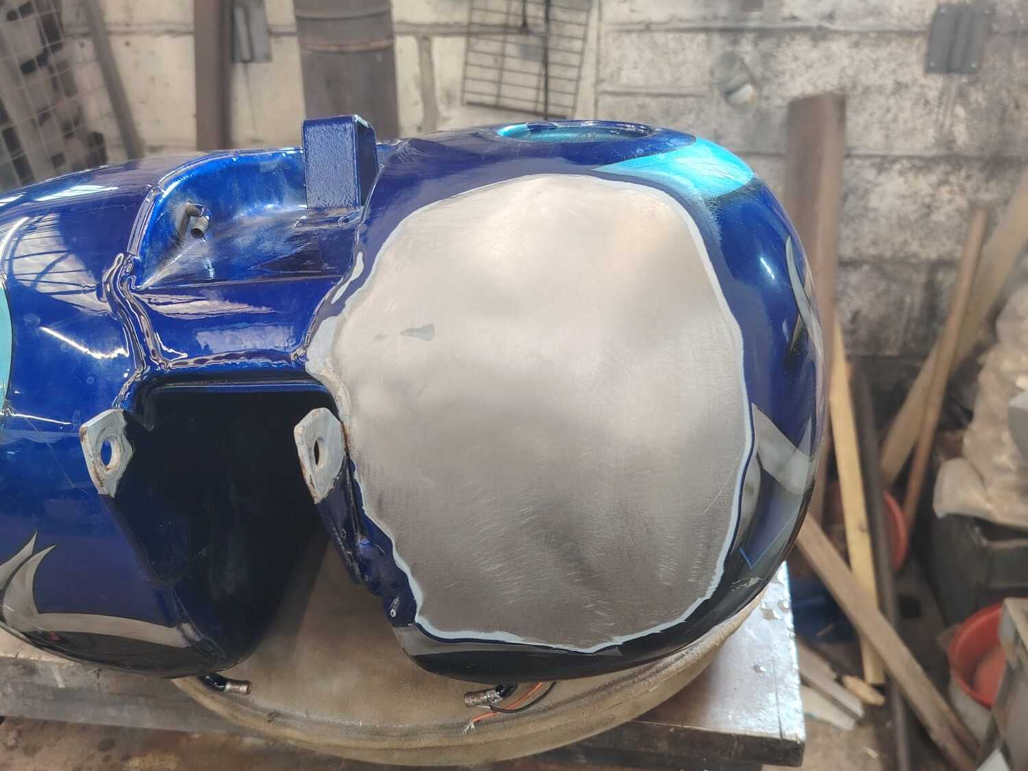 Harley-Davidson tank repaired, new metal beside the custom paint