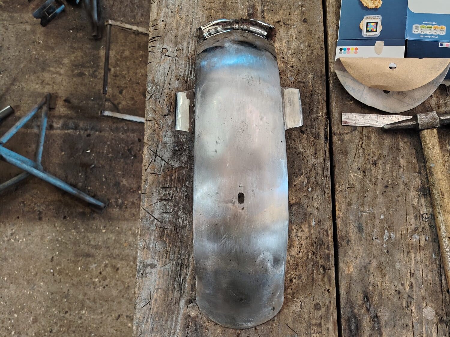 The Monkey bike mudguard repaired, in bare steel on the bench