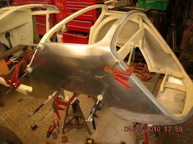Hand-forming a body panel over the frame