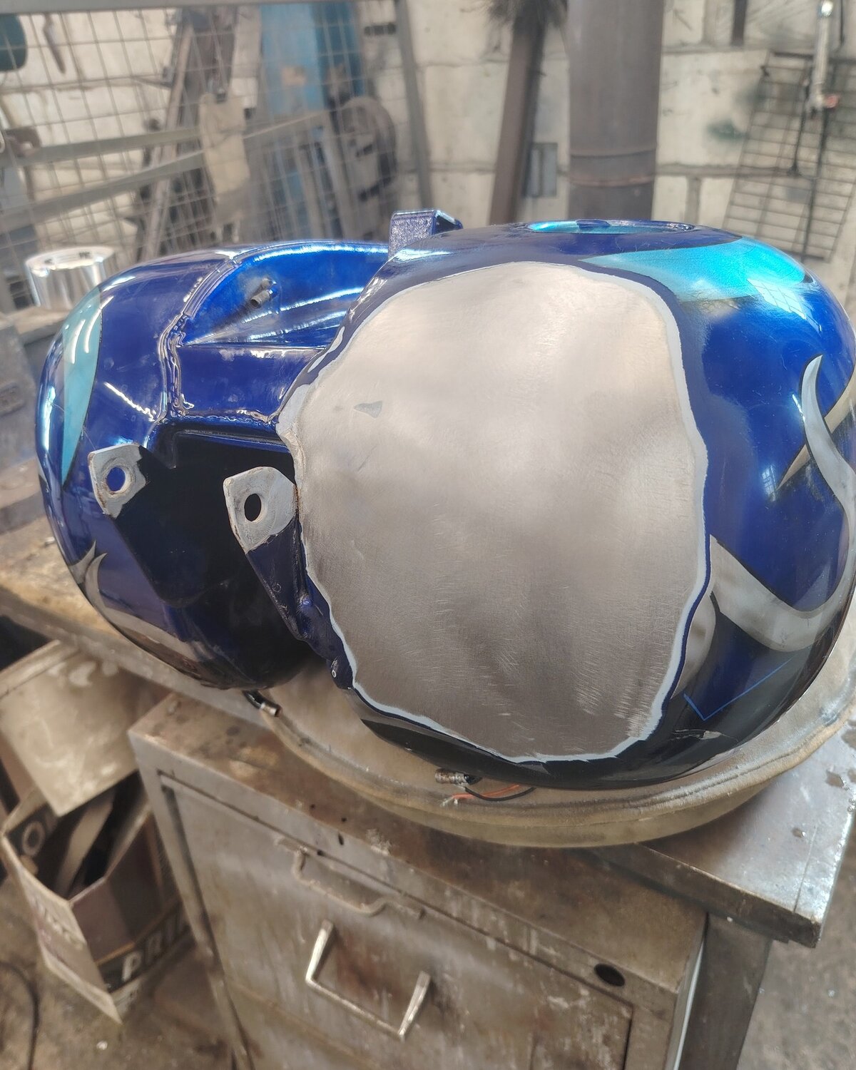 Modern Harley-Davidson fuel tank with custom paint, repaired with new metal